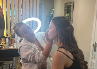Makeup artist beautifying a client at Eden Salon, Tyldesley, England, GB with professional aesthetics.