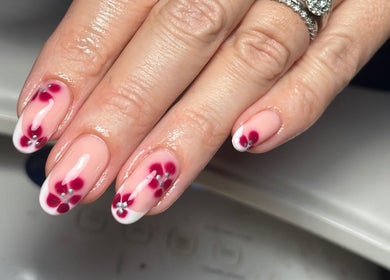 Floral nail design at Nails and Beauty by Sarah, Huddersfield, England, GB. Elegant pink and white petals.