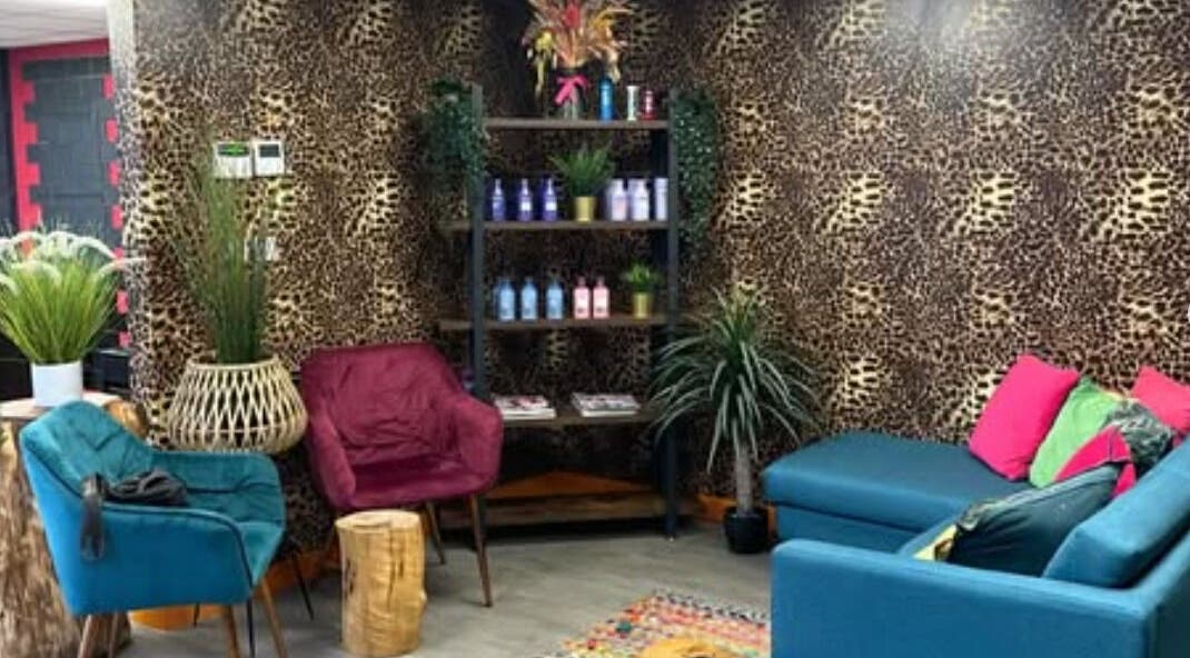 Chic lounge area with leopard print at Signature Hair, Alfreton, England, GB, vibrant seating, stylish decor.