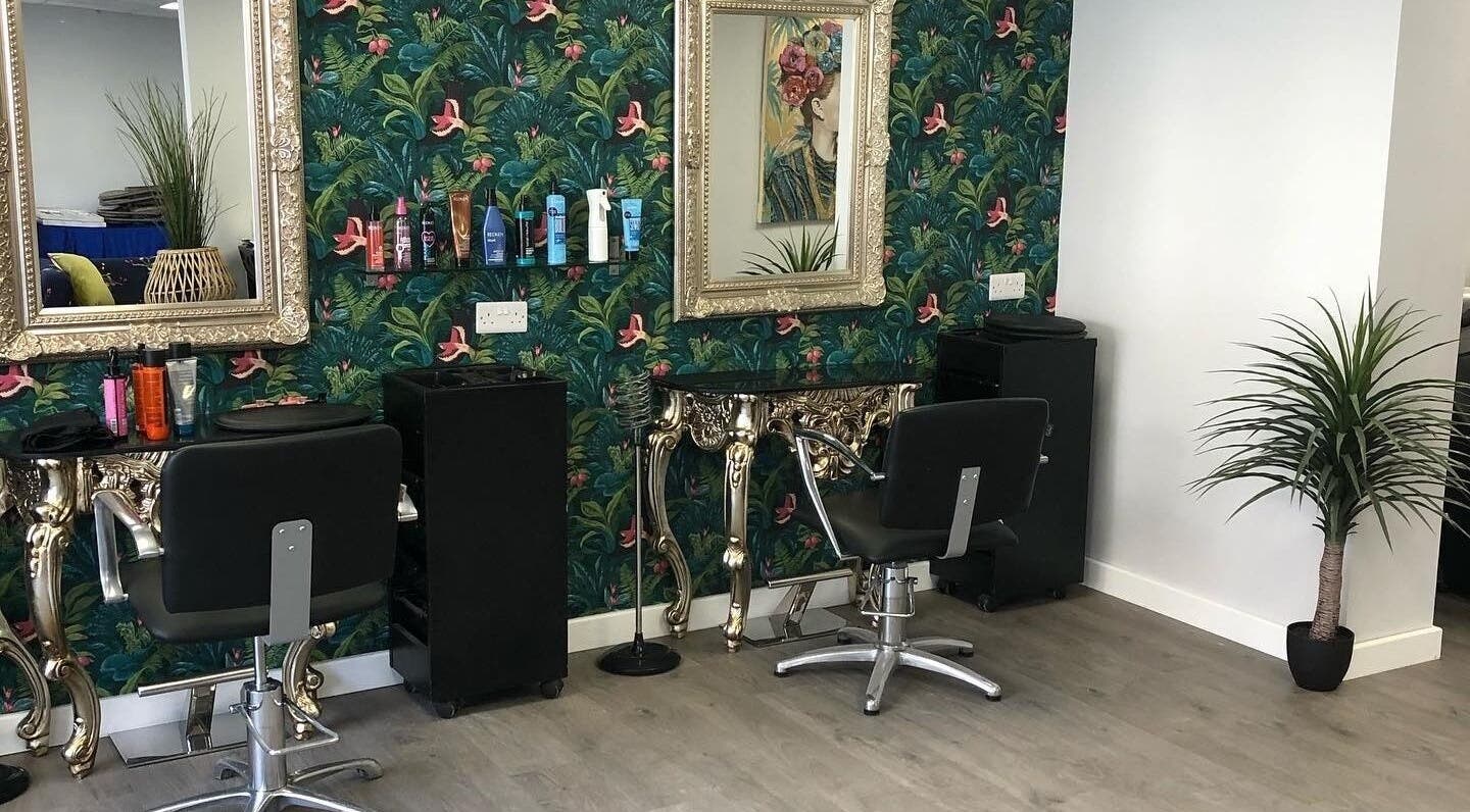 Chic salon interior at Signature Hair in Alfreton, England, GB with stylish decor and styling stations.