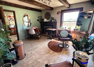 Inviting salon interior at Hair By Holly llc, Nederland, Colorado, US showcasing plants and comfortable seating.