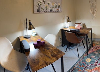 Inviting salon interior at Hair By Holly llc, Nederland, Colorado, US with wooden tables and chic decor.