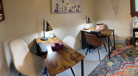 Inviting salon interior at Hair By Holly llc, Nederland, Colorado, US with wooden tables and chic decor.