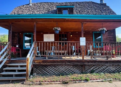 Charming facade of Hair By Holly llc, a wellness venue in Nederland, Colorado, US with wooden porch seating.