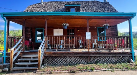 Charming facade of Hair By Holly llc, a wellness venue in Nederland, Colorado, US with wooden porch seating.