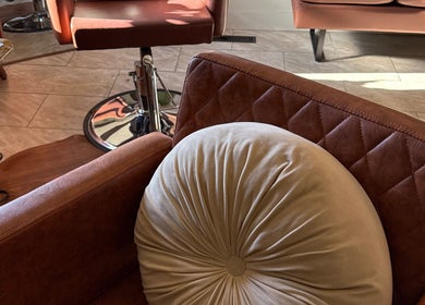 Comfortable seating at Hair By Holly llc, Nederland, Colorado, US, highlighting plush interiors.