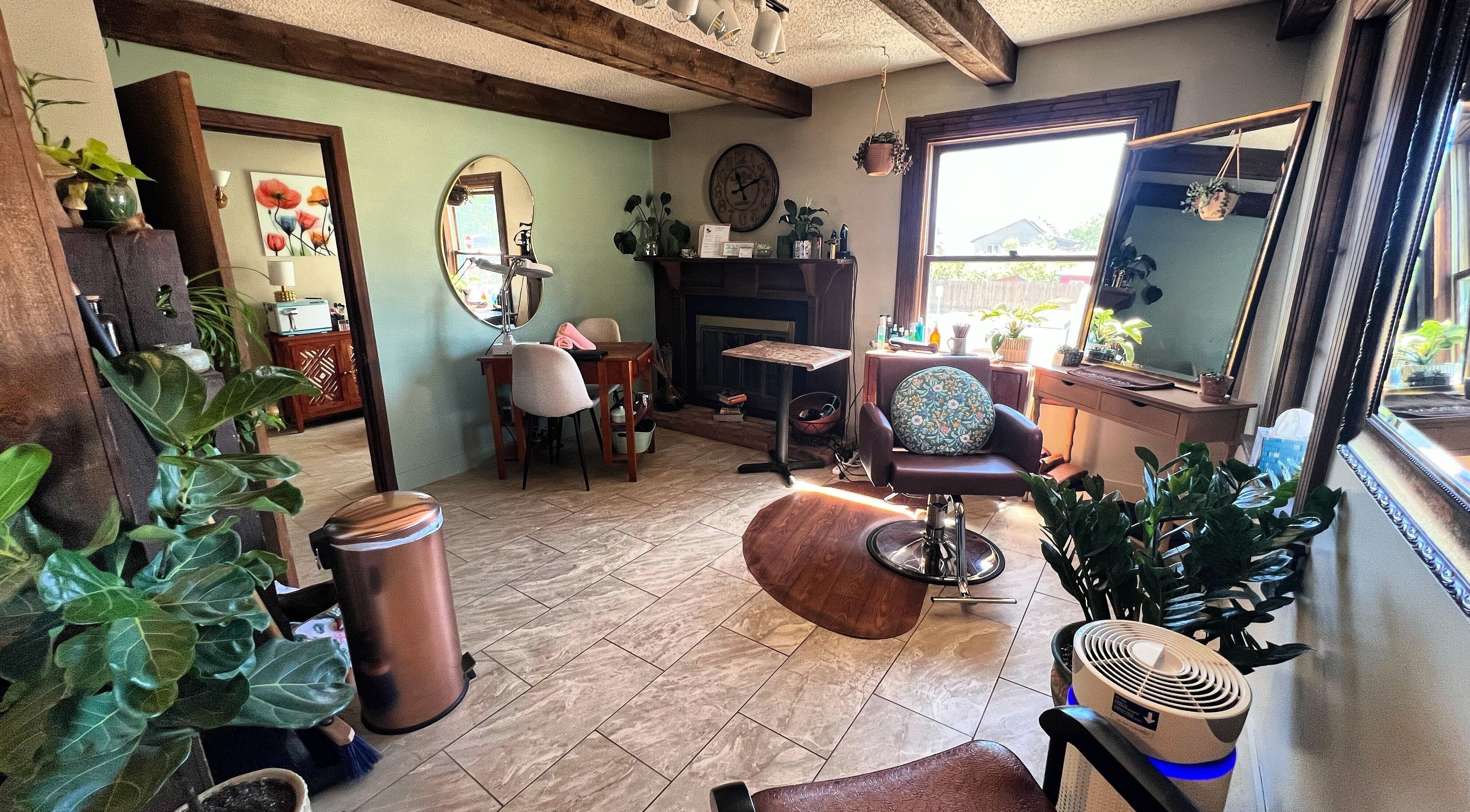 Inviting beauty salon interior of Hair By Holly llc in Nederland, Colorado, US, with warm decor and greenery.