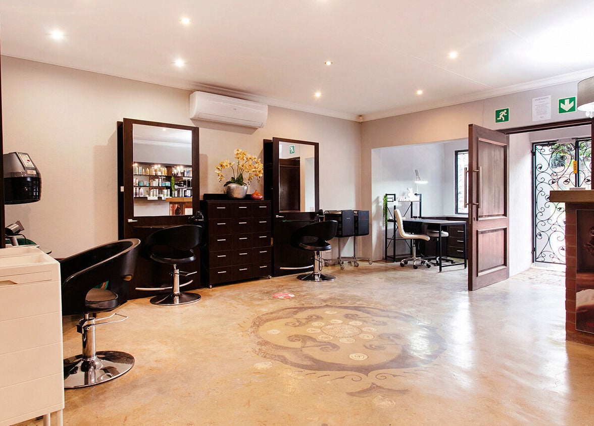 Chic interior at Authentic Collection, Pretoria, Gauteng, ZA featuring modern salon furniture and bright décor.