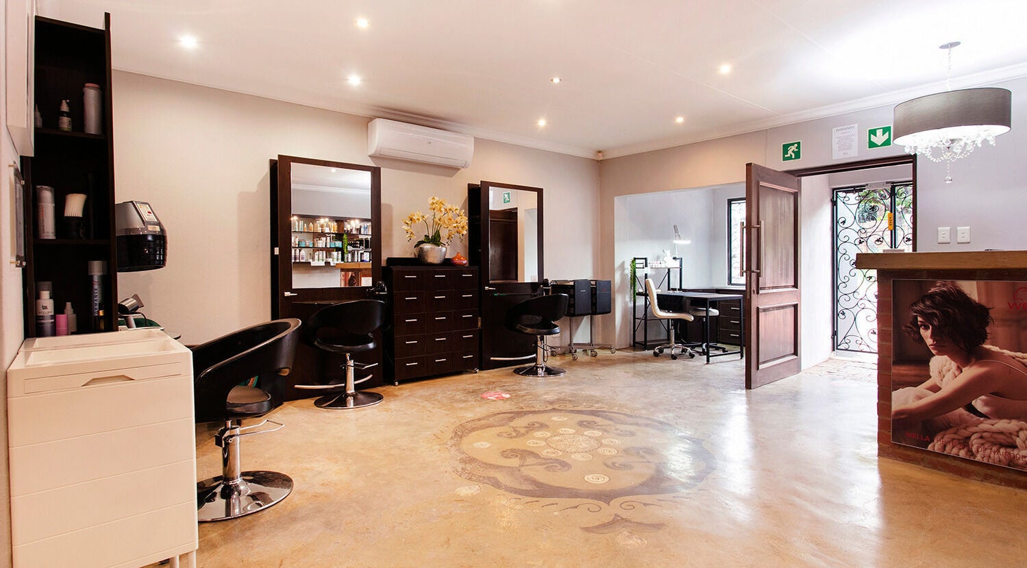 Chic interior at Authentic Collection, Pretoria, Gauteng, ZA featuring modern salon furniture and bright décor.