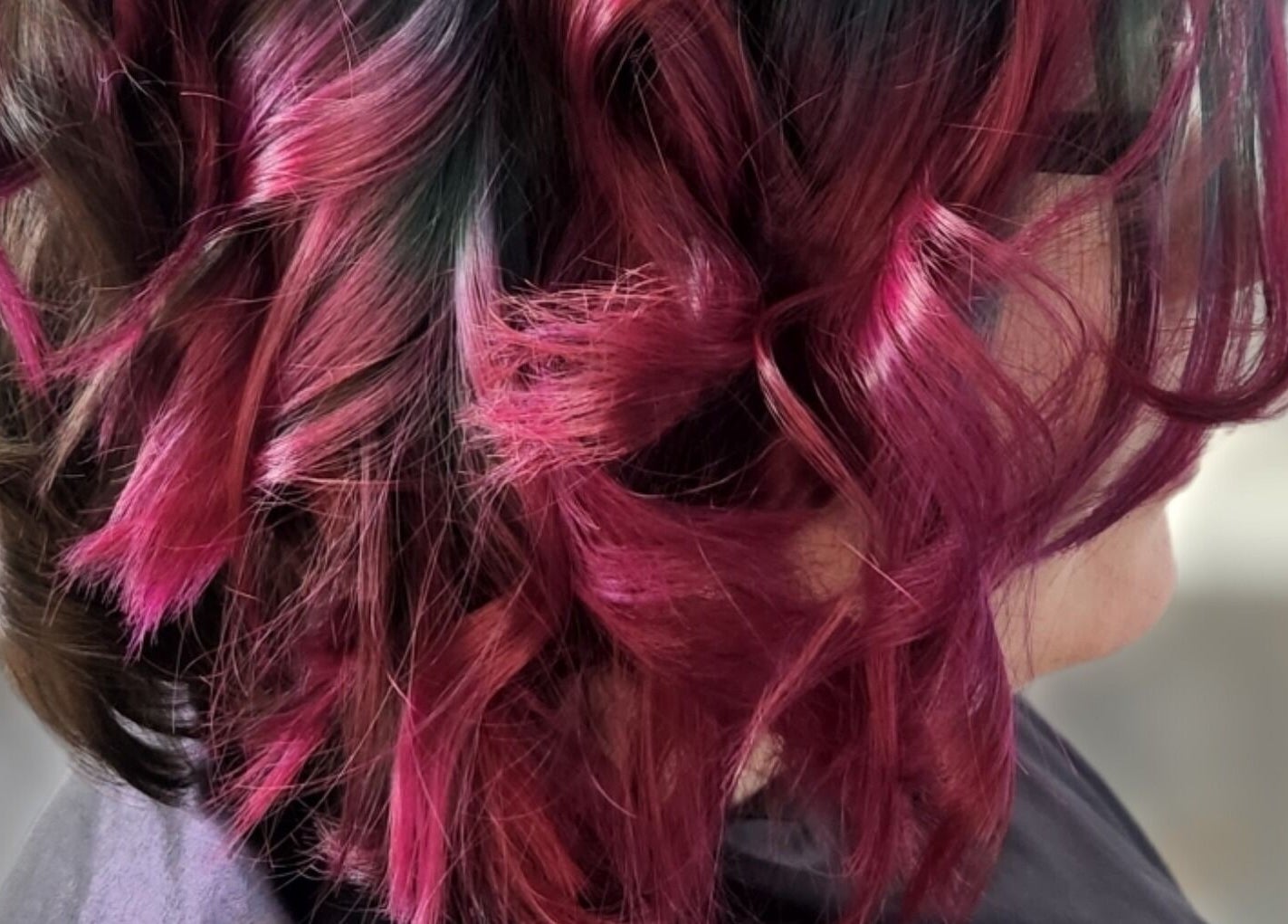 Vibrant pink and black curls styled at Ice and Glow Beauty and Wellness Center LLC in Ft Worth, Texas, US.