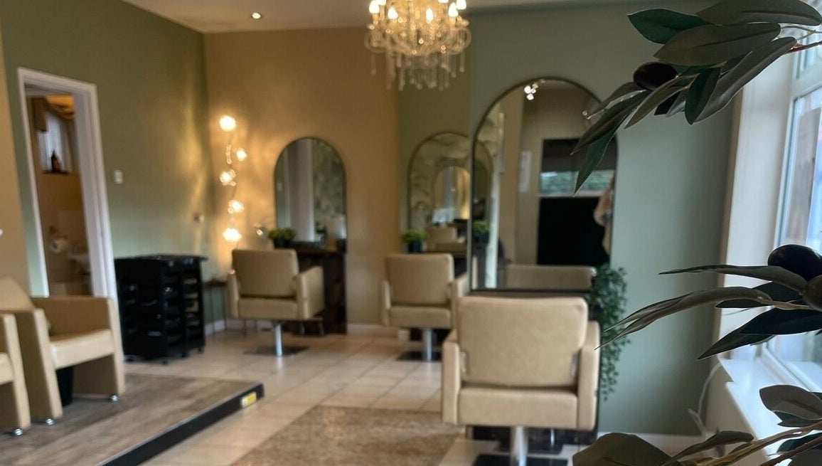 Chic and modern interior of The Salon, Marchwiel, Wales, GB, featuring plush chairs and ambient lighting.