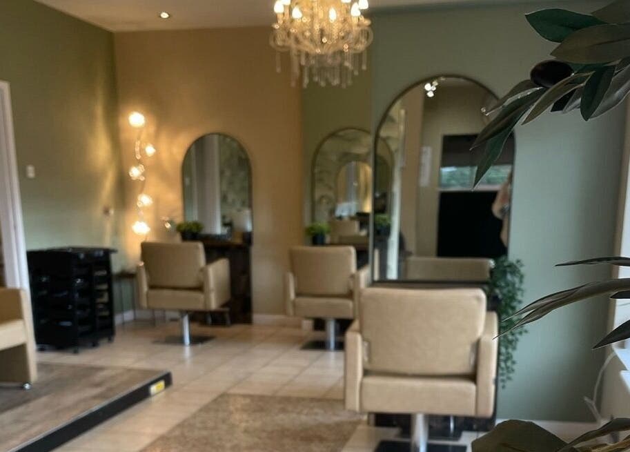 Chic and modern interior of The Salon, Marchwiel, Wales, GB, featuring plush chairs and ambient lighting.