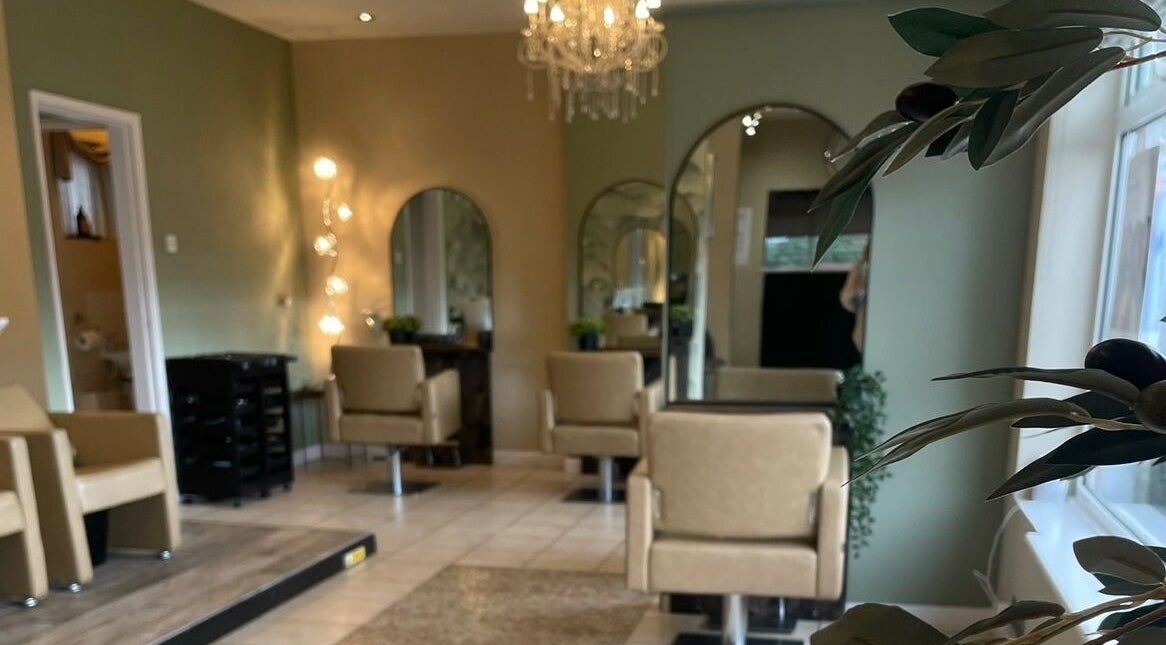 Chic and modern interior of The Salon, Marchwiel, Wales, GB, featuring plush chairs and ambient lighting.