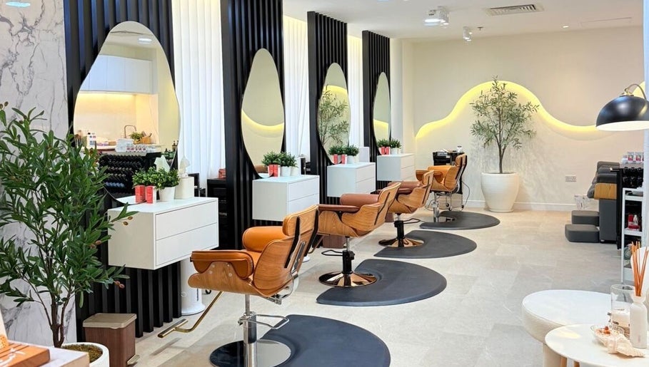 Chic interior of Off White Salon & Spa in Abu Dhabi, Abu Dhabi, AE showcasing stylish salon chairs and mirrors.
