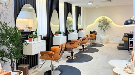 Chic interior of Off White Salon & Spa in Abu Dhabi, Abu Dhabi, AE showcasing stylish salon chairs and mirrors.
