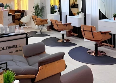 Modern interior of Off White Salon & Spa in Abu Dhabi, AE featuring stylish salon chairs and mirrors.