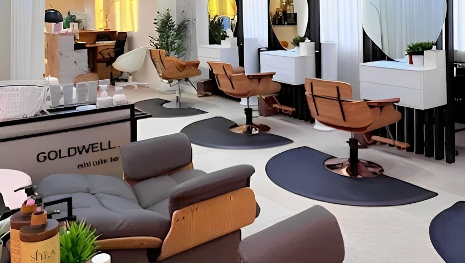Chic interior of Off White Salon & Spa in Abu Dhabi, AE featuring modern salon chairs and mirrors.