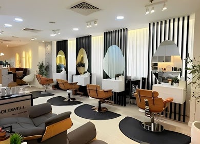 Modern interior of Off White Salon & Spa, Abu Dhabi, AE with stylish seating and mirrors.