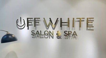 Stylish Off White Salon & Spa logo on accent wall, Abu Dhabi, AE. Modern décor with elegant lighting.