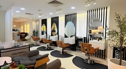 Modern salon interior at Off White Salon & Spa, Abu Dhabi, AE, showcasing stylish chairs and mirrors.