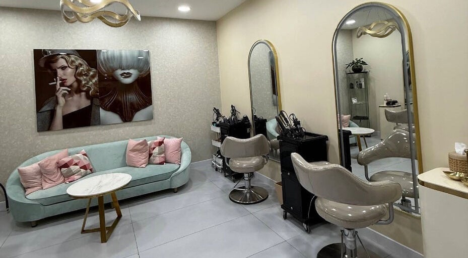 Modern interior of Moora Beauty Salon in Dubai, Dubai, AE featuring stylish seating and elegant mirrors.