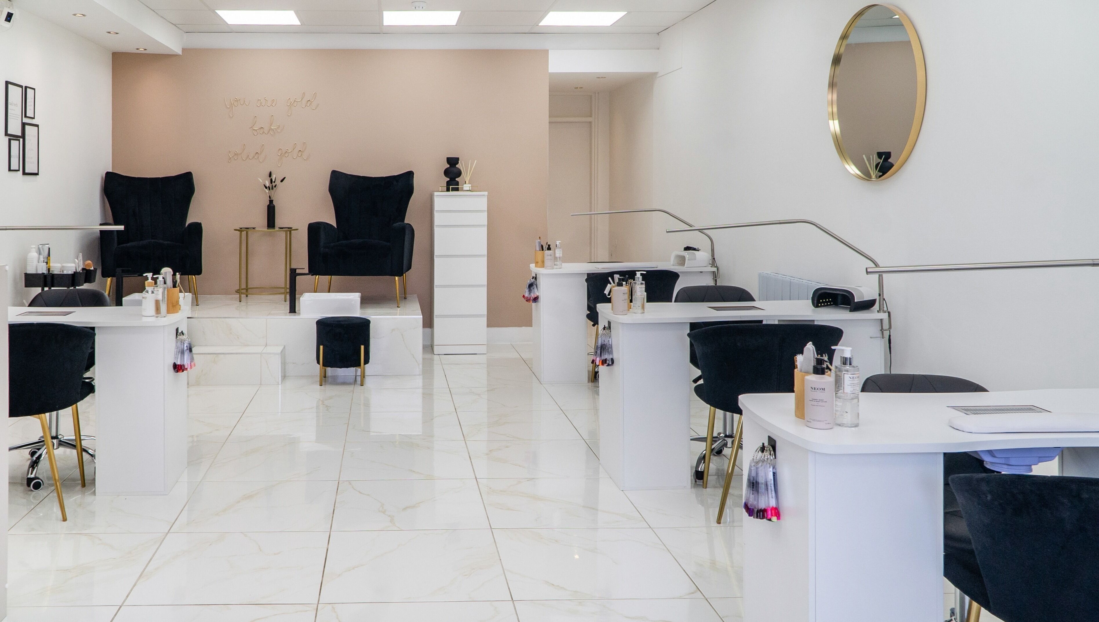 Modern, chic nail salon interior at Josie & Co, Lytham St Annes, England, GB, featuring plush seating and polished decor.