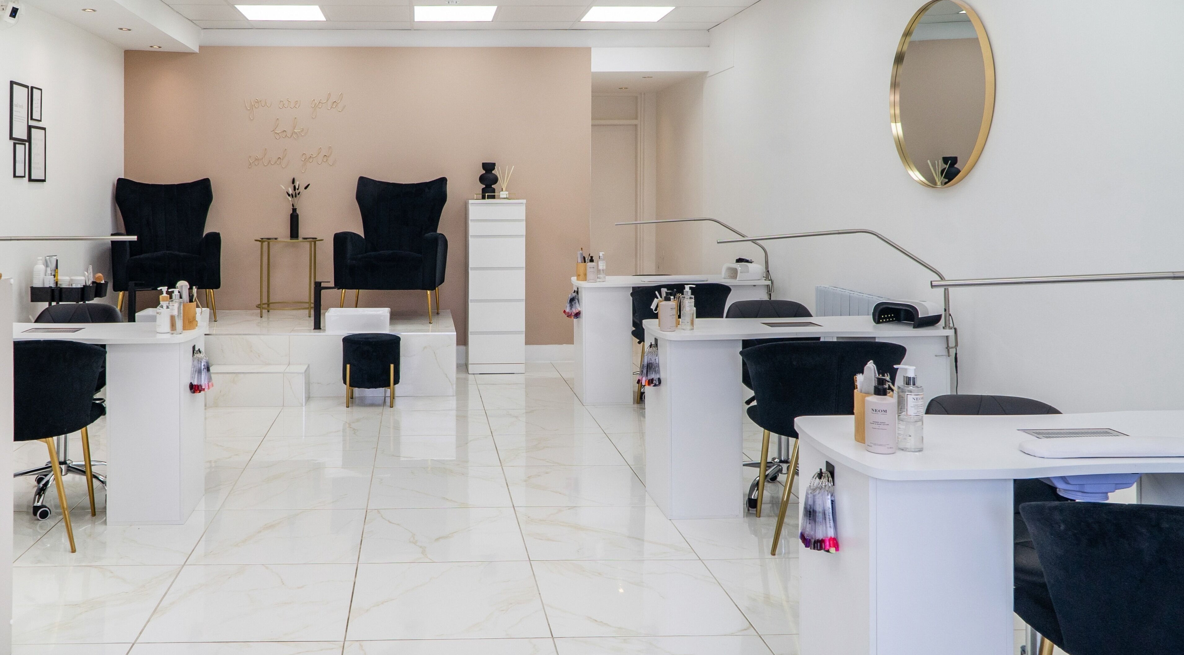 Modern, chic nail salon interior at Josie & Co, Lytham St Annes, England, GB, featuring plush seating and polished decor.