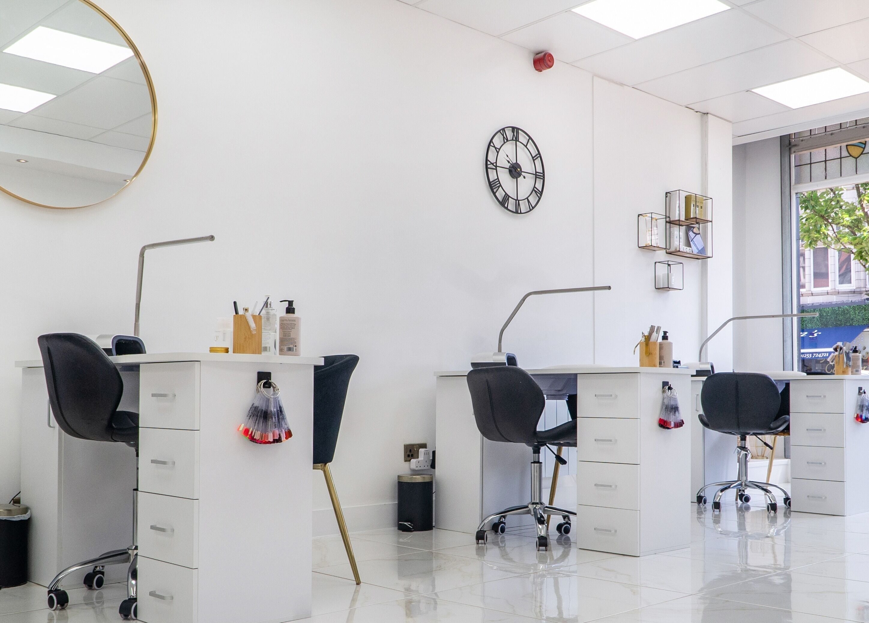 Modern salon interior at Josie & Co in Lytham St Annes, England, GB with stylish workstations and bright lighting.