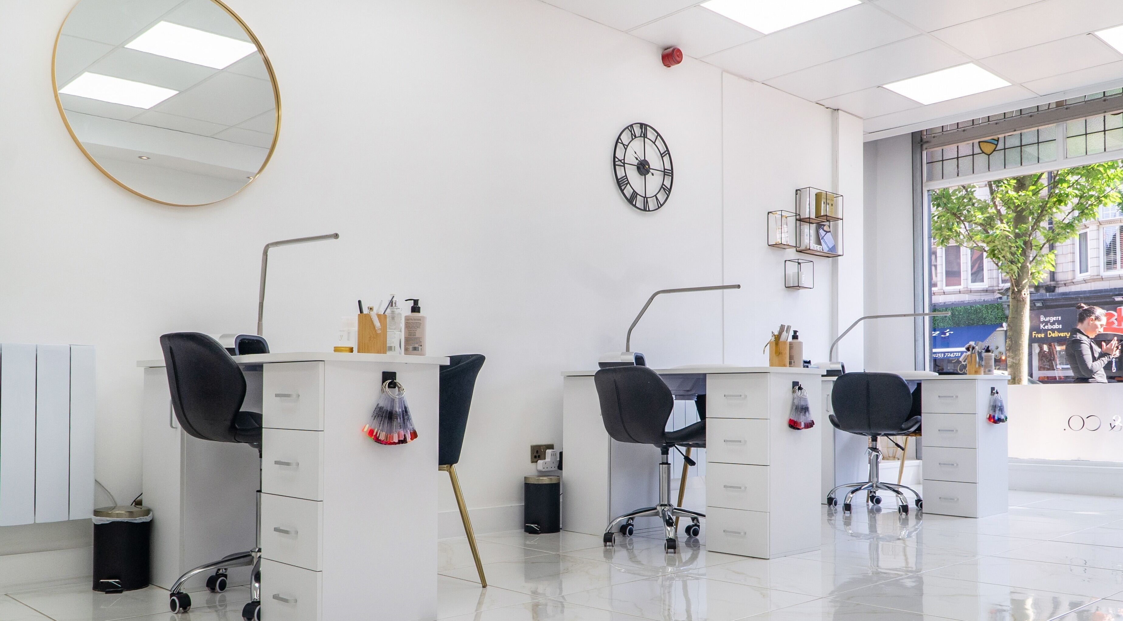 Modern salon interior at Josie & Co in Lytham St Annes, England, GB with stylish workstations and bright lighting.
