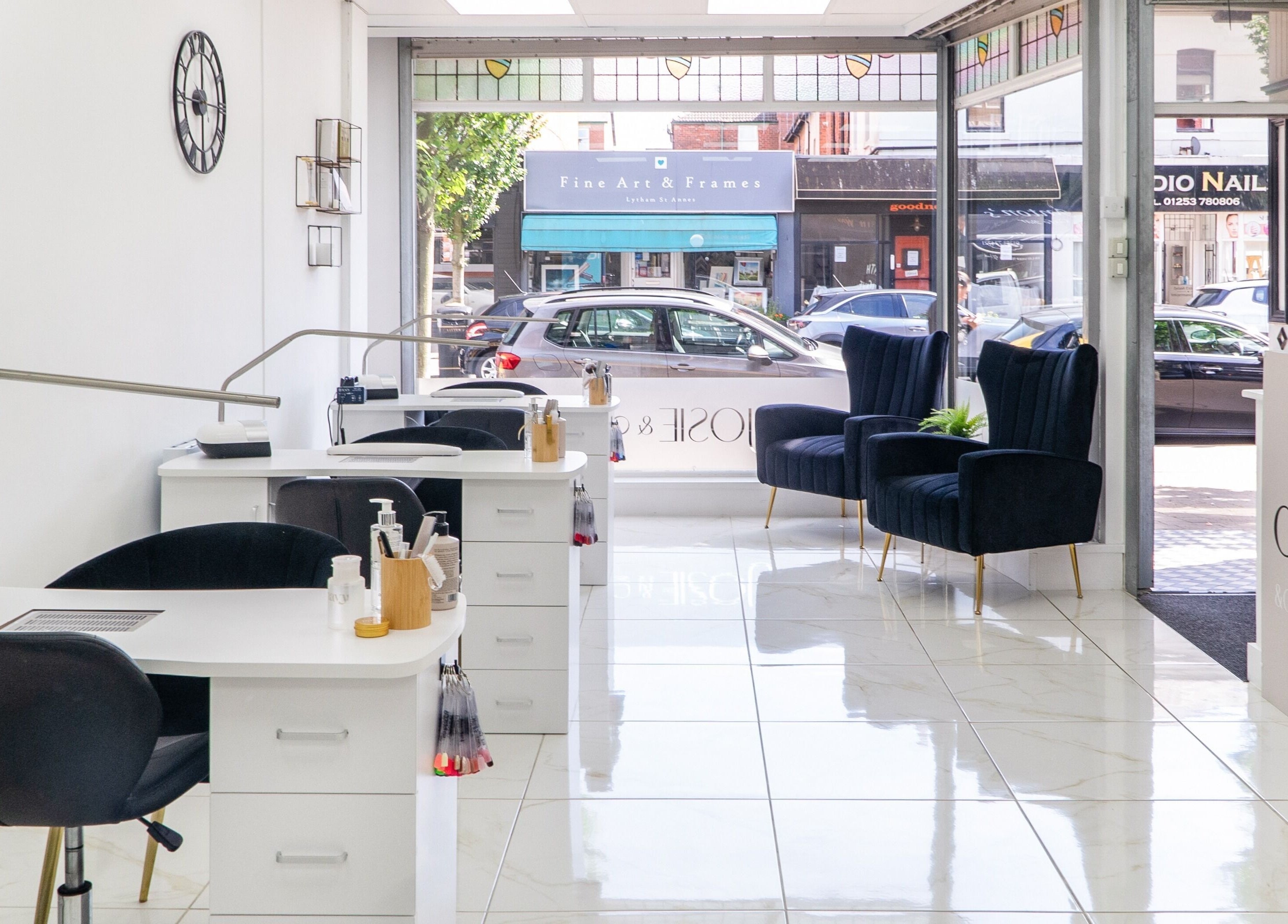 Elegant interior of Josie & Co in Lytham St Annes, England, GB featuring stylish nail stations and plush seating.