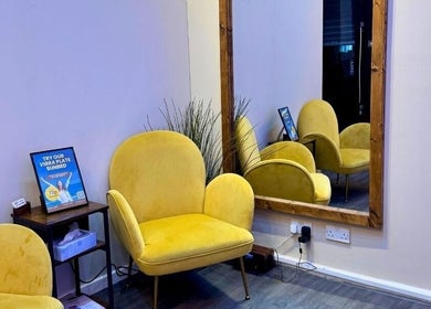 Inviting yellow seating at Shape Zone London, London, England, GB, with elegant mirror and decor.