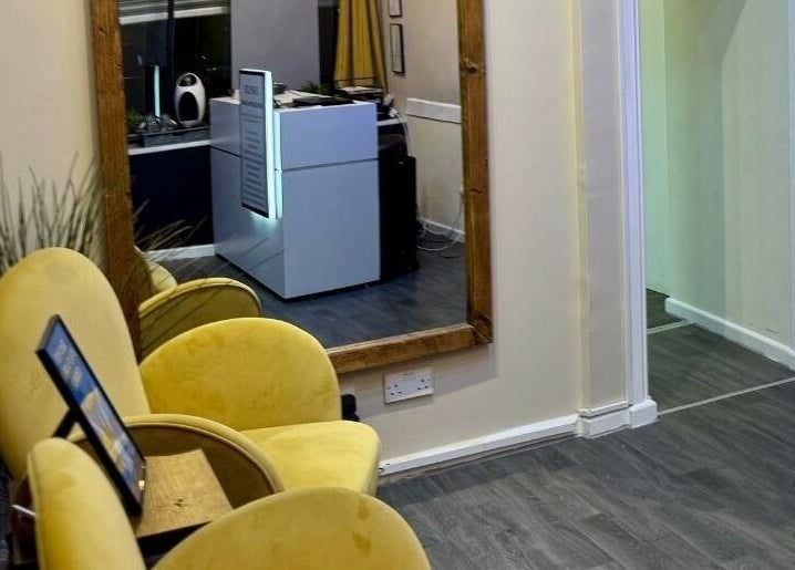 Inviting reception area with yellow chairs at Shape Zone London, London, England, GB, creating a welcoming ambiance.