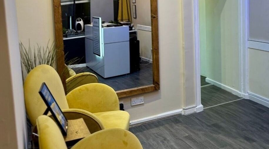 Inviting reception area with yellow chairs at Shape Zone London, London, England, GB, creating a welcoming ambiance.