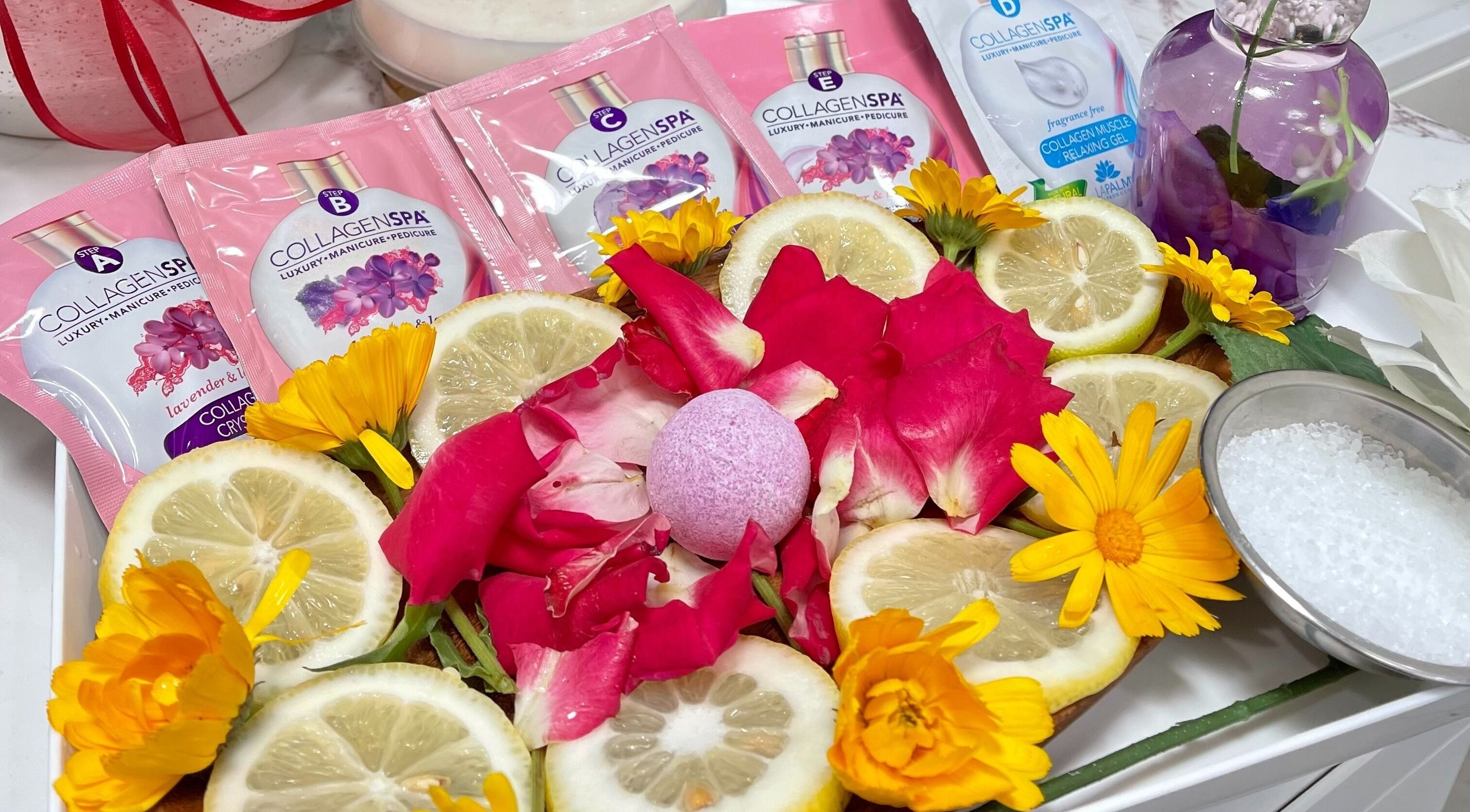 Luxurious spa botanicals at Iconic Nails Studio in Los Altos, California, US, featuring vibrant petals and citrus.