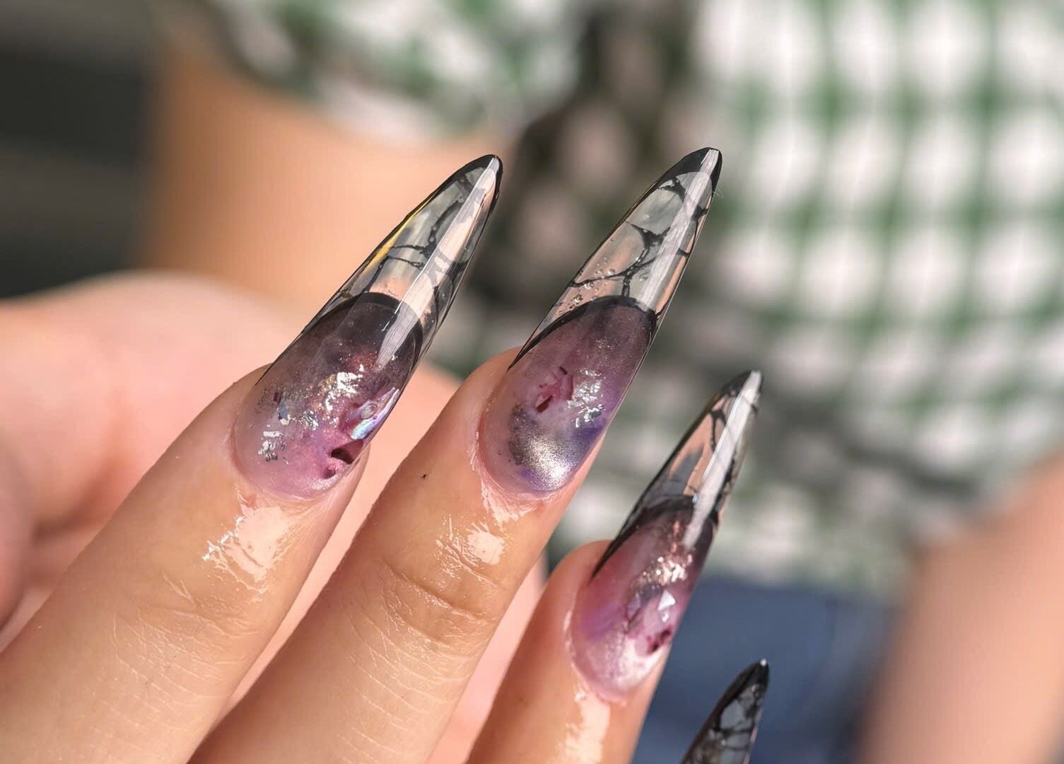 Elegant stiletto nails with purple and black design at Iconic Nails Studio, Los Altos, California, US.