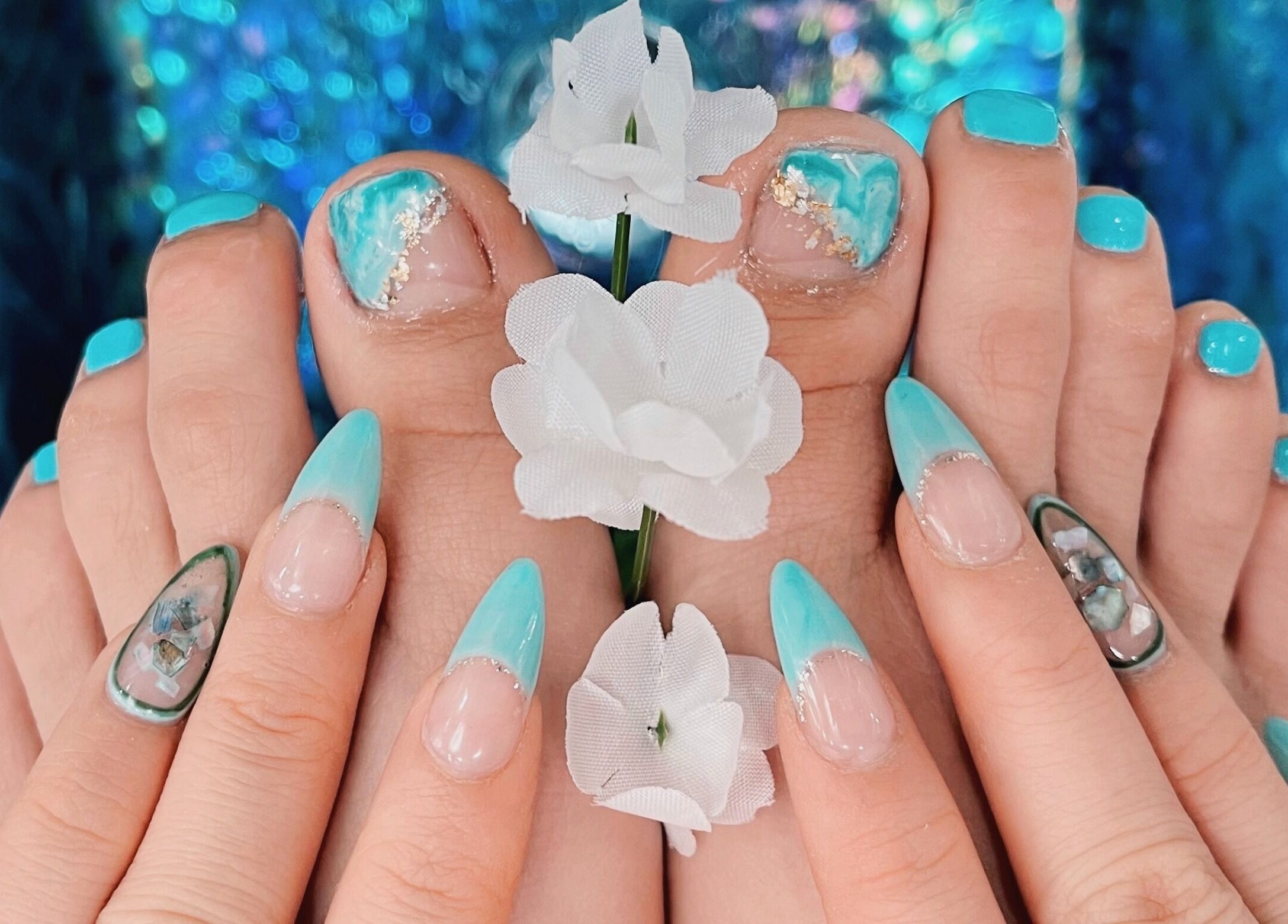 Vibrant blue nails at Iconic Nails Studio, Los Altos, California, US, with elegant floral accents.