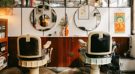 Elegant vintage interior at Lume Hair Studio | Netil Lane, London, England, GB with stylish mirrors and chairs.
