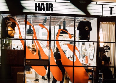 Modern interior of Lume Hair Studio | Netil Lane, London, England, GB, showcasing vibrant design and busy activity.