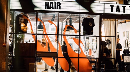 Modern interior of Lume Hair Studio | Netil Lane, London, England, GB, showcasing vibrant design and busy activity.