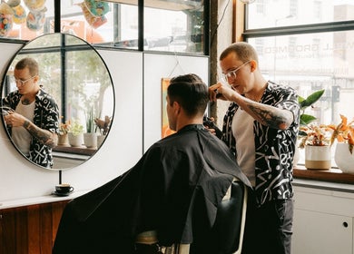 Stylist cutting hair at Lume Hair Studio | Netil Lane, London, England, GB with modern decor.