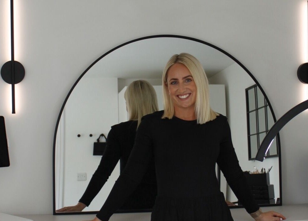 Elegant woman in black at Just Do Fab, Brighton And Hove, England, GB, with modern decor.