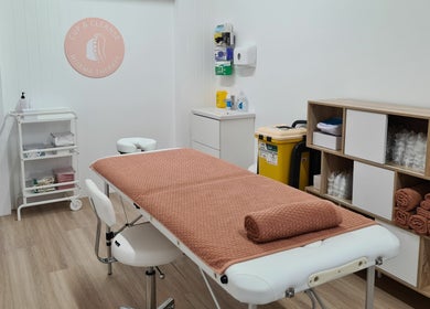 Cup & Cleanse treatment room at Runaway Bay, Queensland, AU with massage table and warm decor.