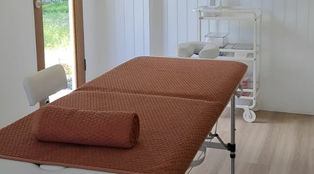 Relaxing massage room at Cup & Cleanse, Runaway Bay, Queensland, AU with a cozy treatment bed.