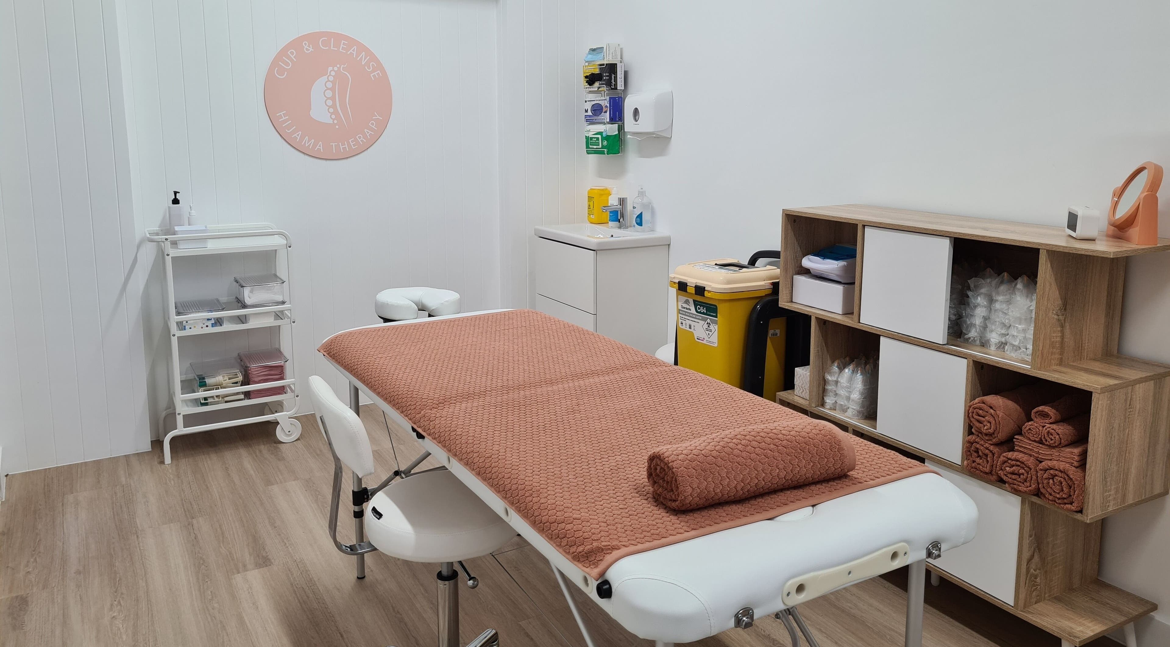 Serene treatment room at Cup & Cleanse, Runaway Bay, Queensland, AU with massage table and equipment.