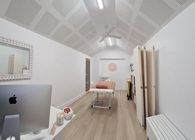 Calm, well-lit therapy room at Cup & Cleanse, Runaway Bay, Queensland, AU, featuring modern decor and therapy bed.