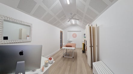 Calm, well-lit therapy room at Cup & Cleanse, Runaway Bay, Queensland, AU, featuring modern decor and therapy bed.