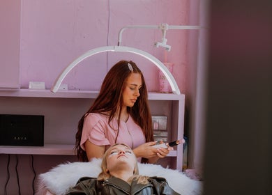 Lash technician applying makeup at Lashesbyrubes in Minehead, England, GB, creating a relaxing atmosphere.