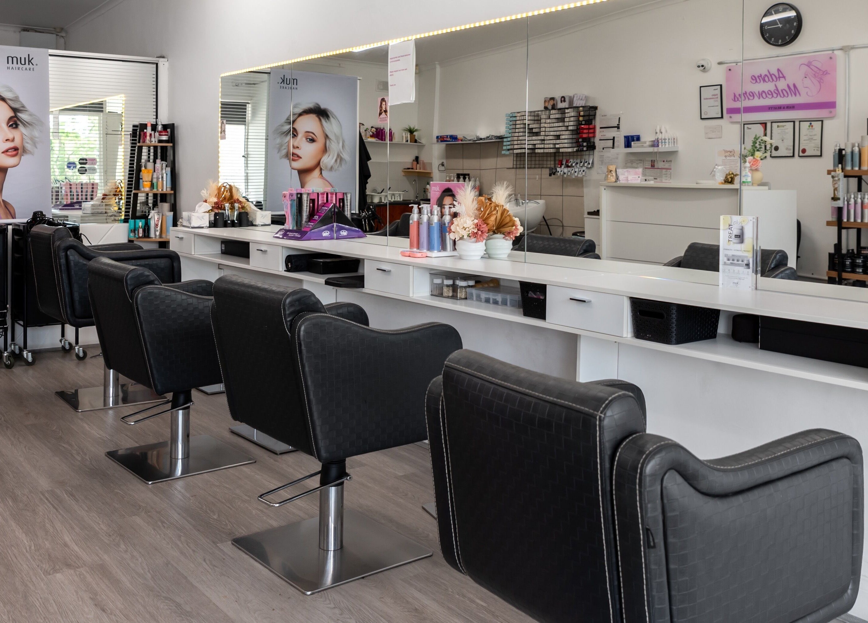 Modern beauty salon interior at Adore Makeovers in Newton, South Australia, AU, featuring elegant styling chairs.