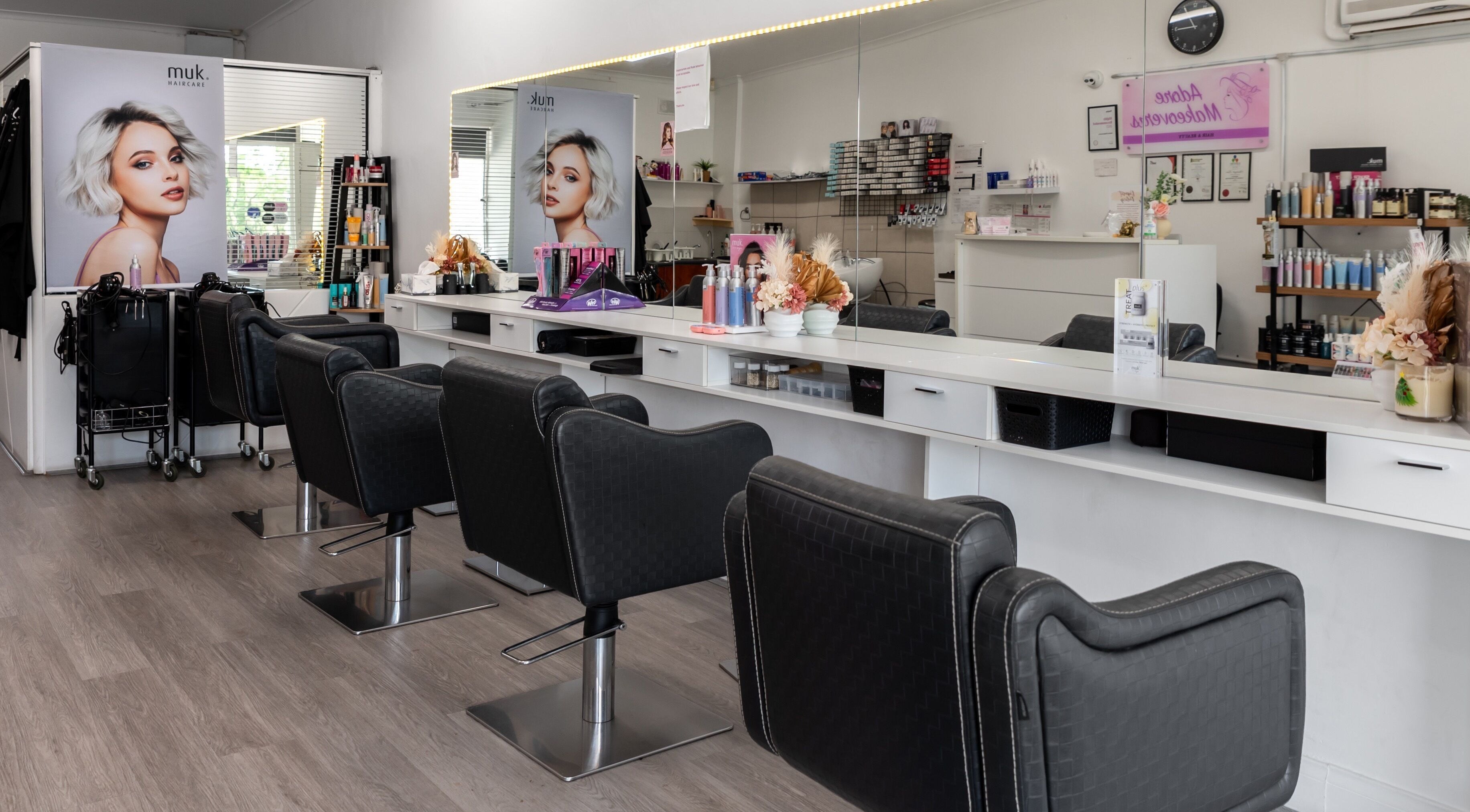 Modern beauty salon interior at Adore Makeovers in Newton, South Australia, AU, featuring elegant styling chairs.