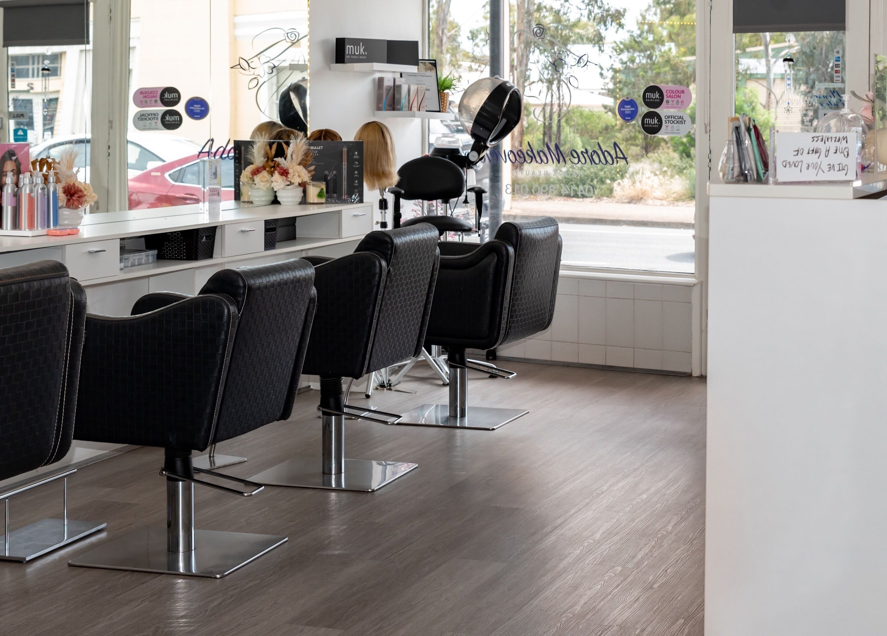 Modern interior of Adore Makeovers salon in Newton, South Australia, AU with stylish black chairs.